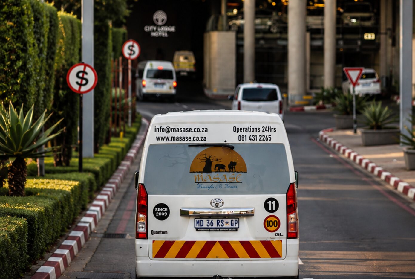 A Masase vehicle on the road, with highway signage toward Pretoria and Johannesburg